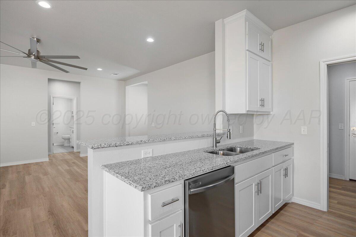 4204 Beacon Road Amarillo, TX 79118 - Photo 8 of 19 a kitchen with stainless steel appliances granite countertop a sink stove and cabinets