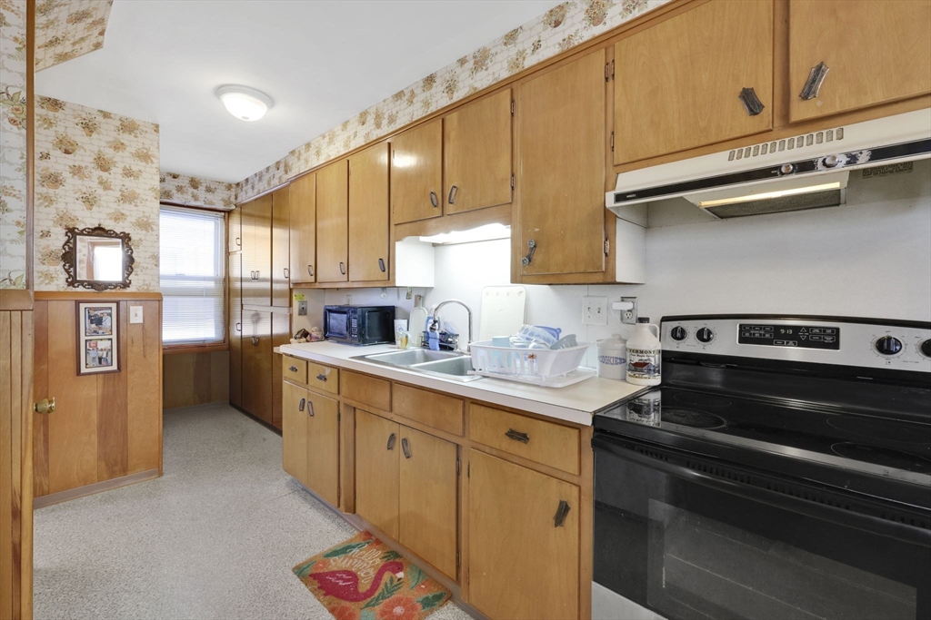 59 Prospect Street Ludlow, MA 01056 - Photo 12 of 42 a kitchen with stainless steel appliances granite countertop a stove and a refrigerator