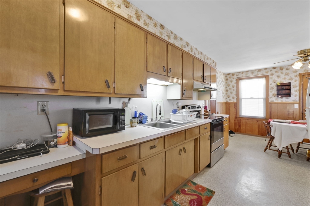 59 Prospect Street Ludlow, MA 01056 - Photo 13 of 42 a kitchen with a sink cabinets and appliances