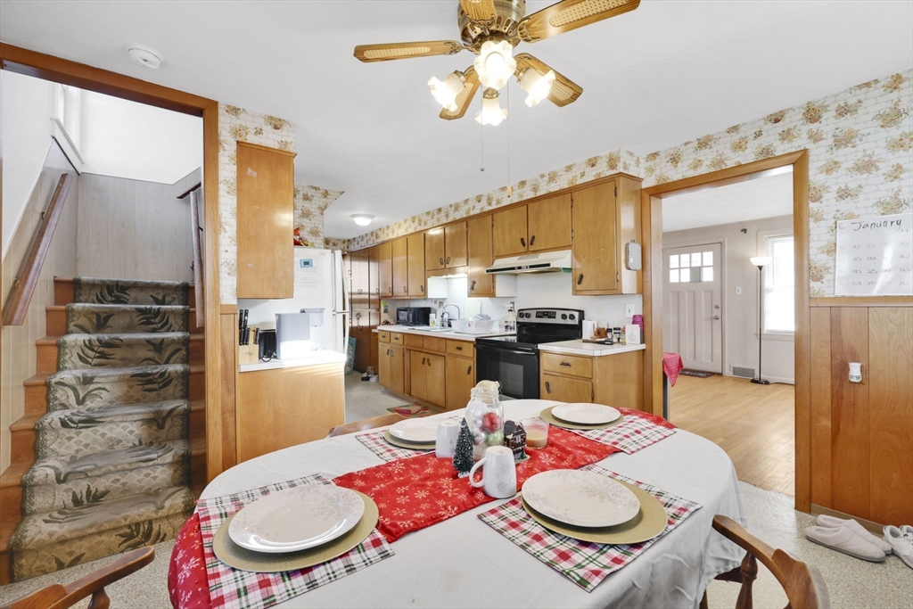 59 Prospect Street Ludlow, MA 01056 - Photo 16 of 42 a open kitchen with stainless steel appliances a dining table and chairs