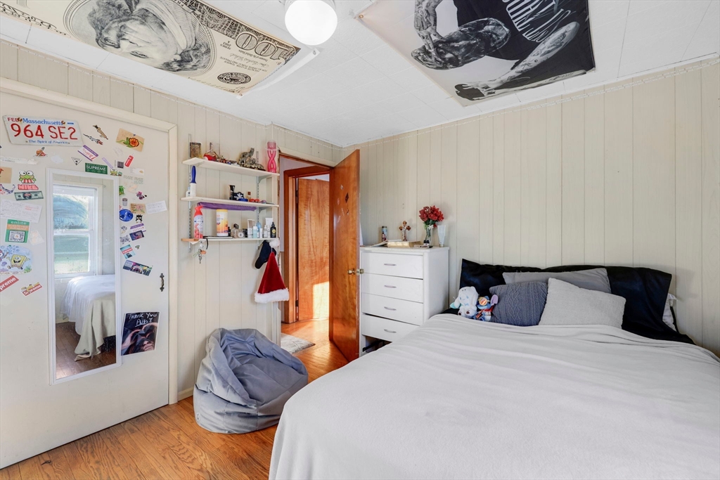 59 Prospect Street Ludlow, MA 01056 - Photo 20 of 42 a bedroom with a bed and wooden floor