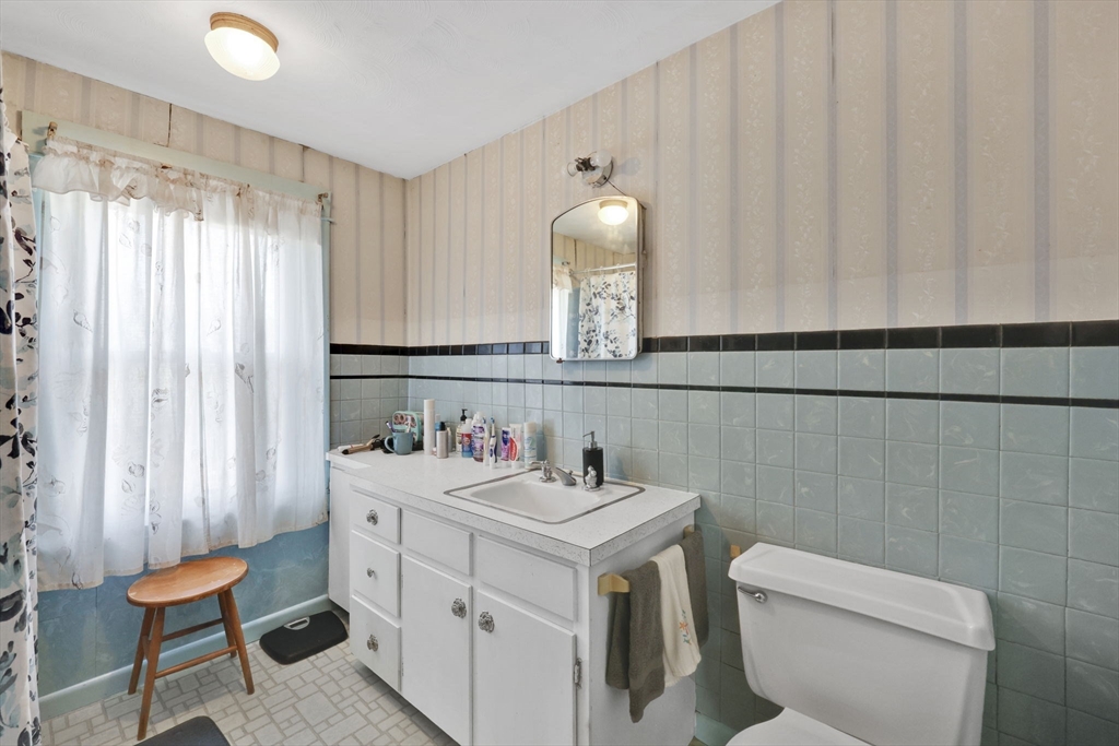 59 Prospect Street Ludlow, MA 01056 - Photo 31 of 42 a bathroom with a sink toilet and mirror
