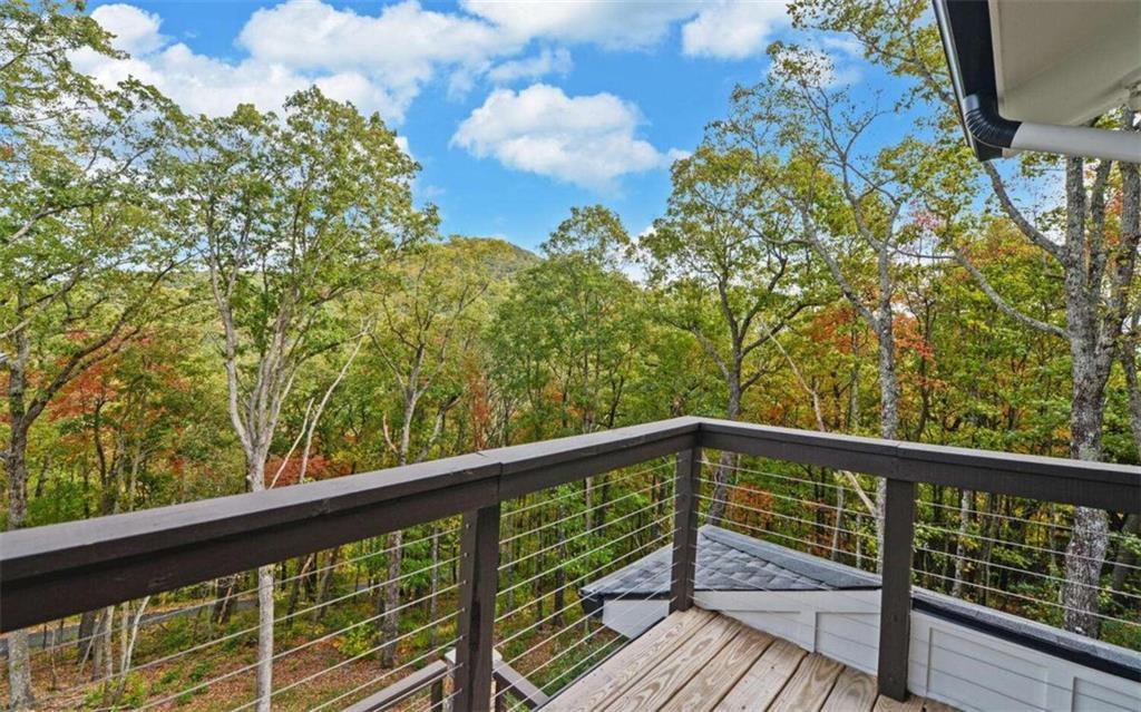 333 Favor Rabun Gap, GA 30568 - Photo 19 of 97 a view of a balcony with wooden floor and fence