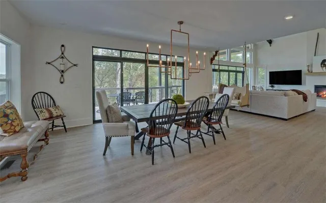 a balcony with wooden floor and outdoor seating
