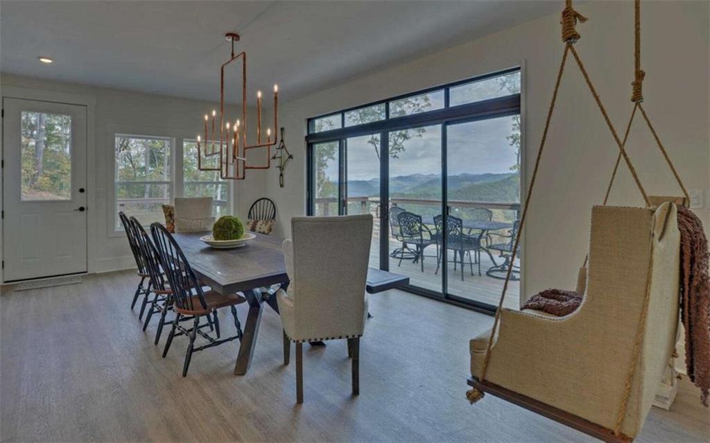 333 Favor Rabun Gap, GA 30568 - Photo 31 of 97 a dining room with furniture a chandelier and wooden floor
