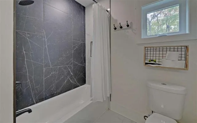 a bed room with a bed and a chair