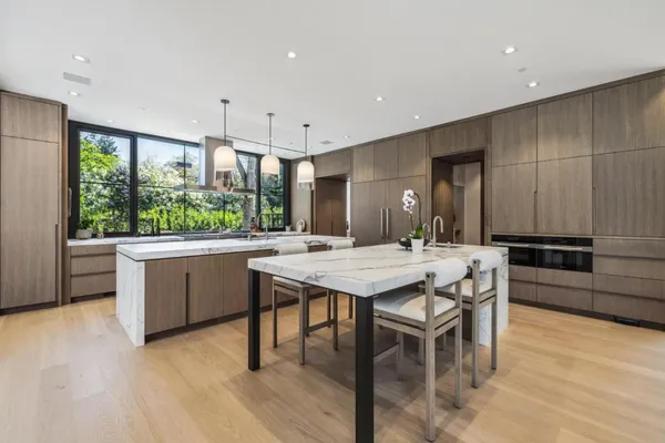 a kitchen with a table and chairs in it