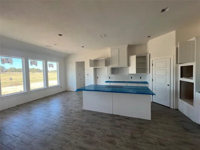 a kitchen with granite countertop a stove and a sink