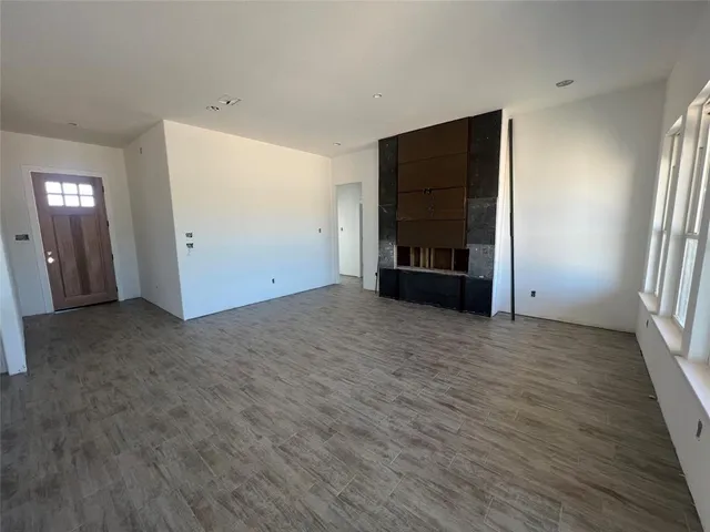 an empty room with closet and wooden floor