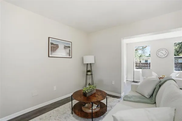 a living room with furniture and a wall painting