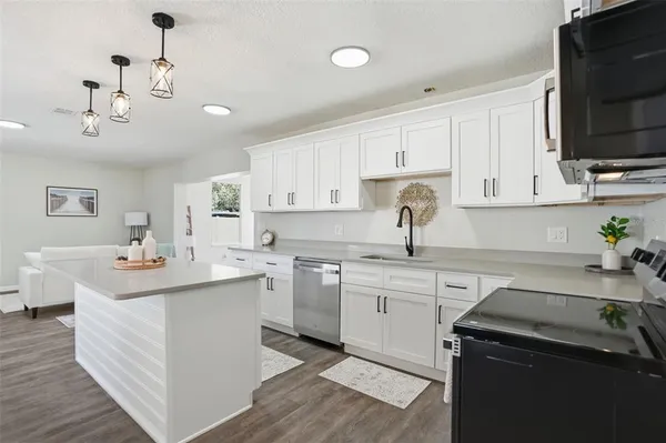 a kitchen with a sink stove and cabinets