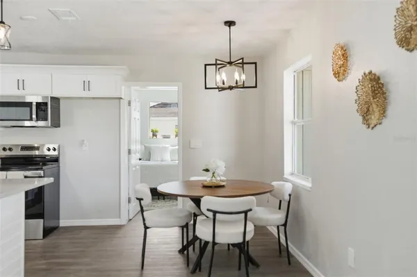 a view of a dining room with furniture wooden floor and a chandelier