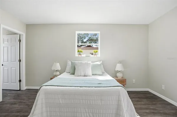 a bedroom with a bed and painting on the wall