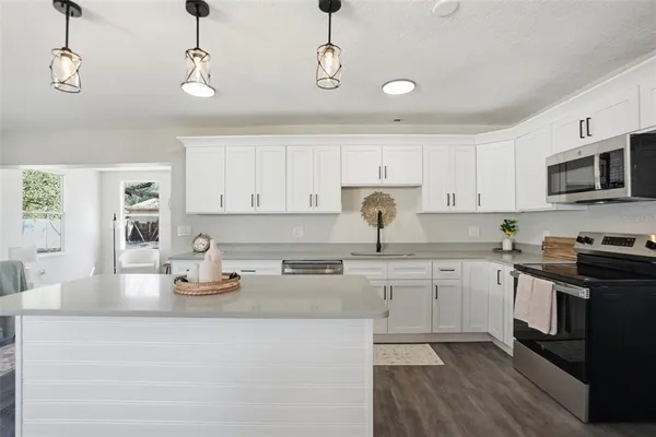 a kitchen with stainless steel appliances granite countertop a sink and stove top oven