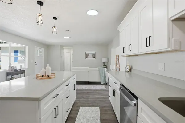 a kitchen with stainless steel appliances a sink stove and cabinets