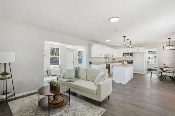 a living room with furniture and wooden floor