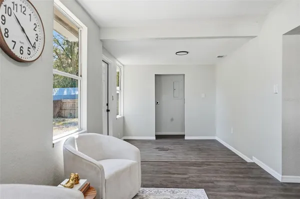 a living room with a bed furniture and a window