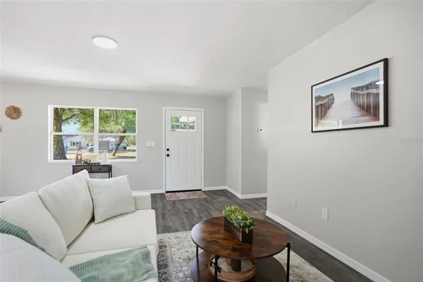 a living room with furniture and a potted plant