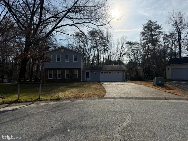 a view of a house with a yard covered with snow