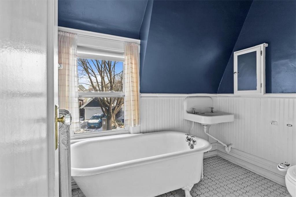 540 Argyle Road Brooklyn, NY 11230 - Photo 14 of 17 a bathroom with a bathtub and a window