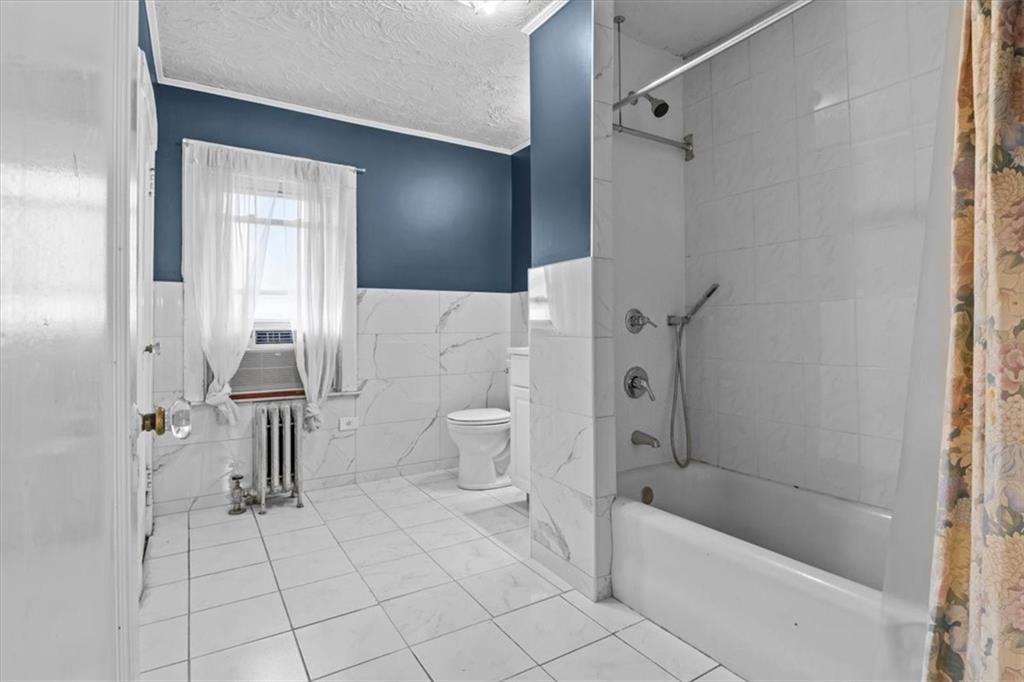 540 Argyle Road Brooklyn, NY 11230 - Photo 15 of 17 a bathroom with a bathtub a toilet and a shower