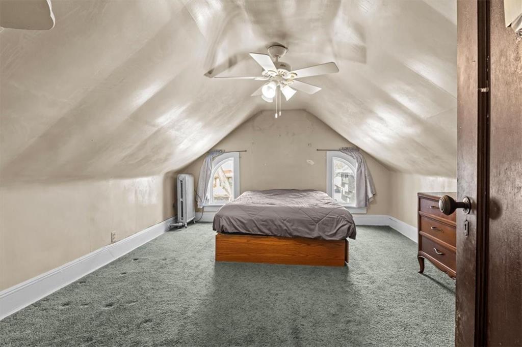 540 Argyle Road Brooklyn, NY 11230 - Photo 16 of 17 a spacious bedroom with a bed and a chandelier