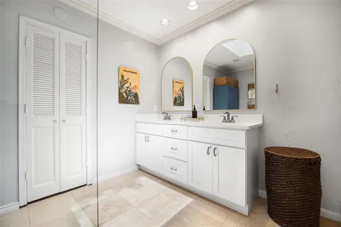 a bathroom with a double vanity sink and a mirror