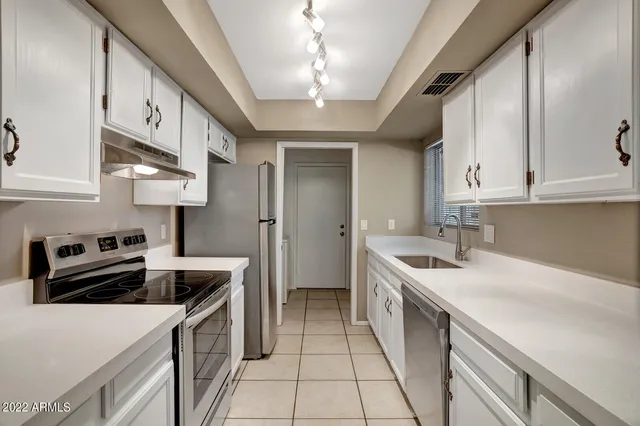 a kitchen with a sink and cabinets