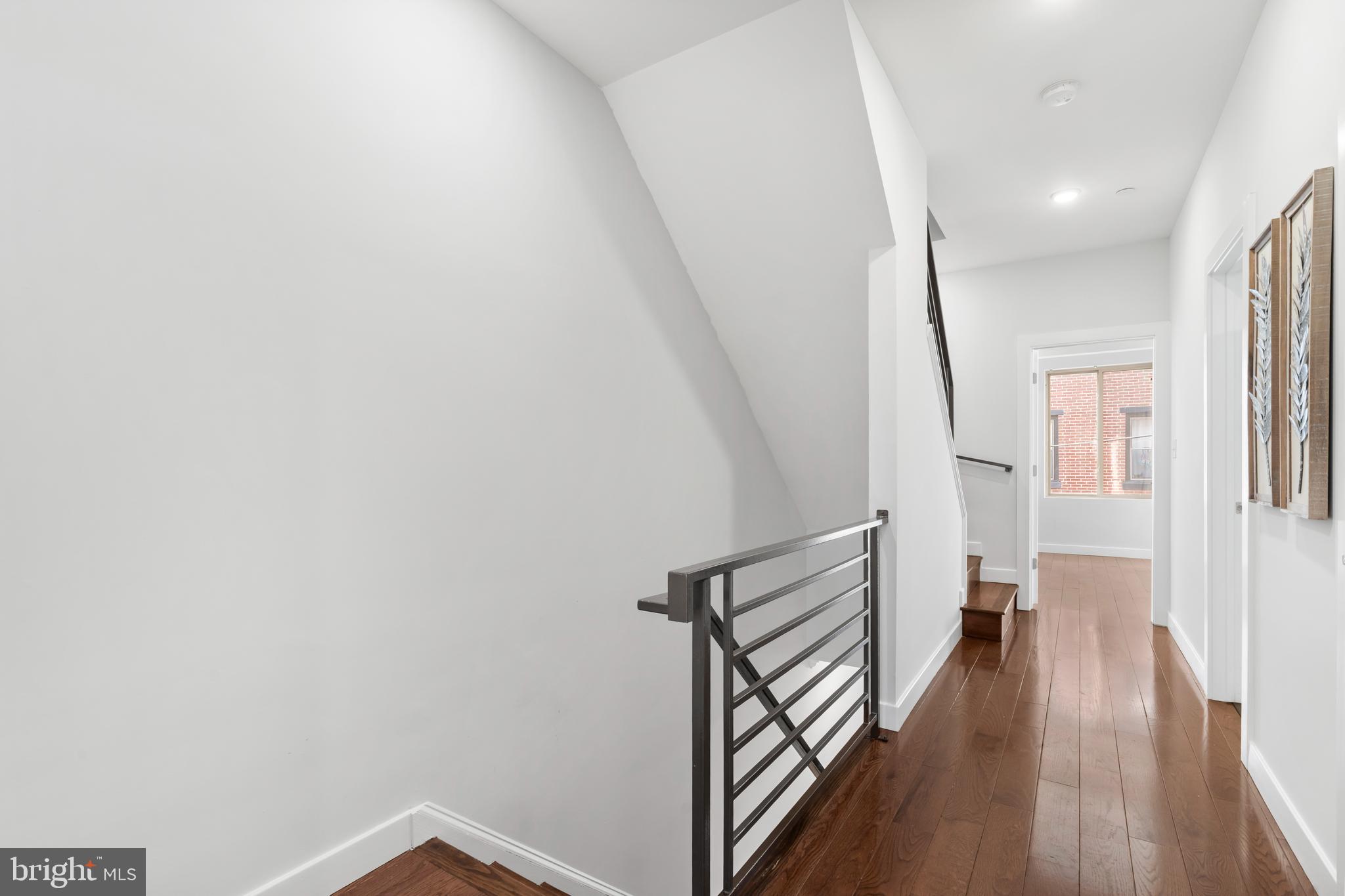 827 Leland Street Philadelphia, PA 19130 - Photo 13 of 40 a view of a hallway with wooden floor and staircase