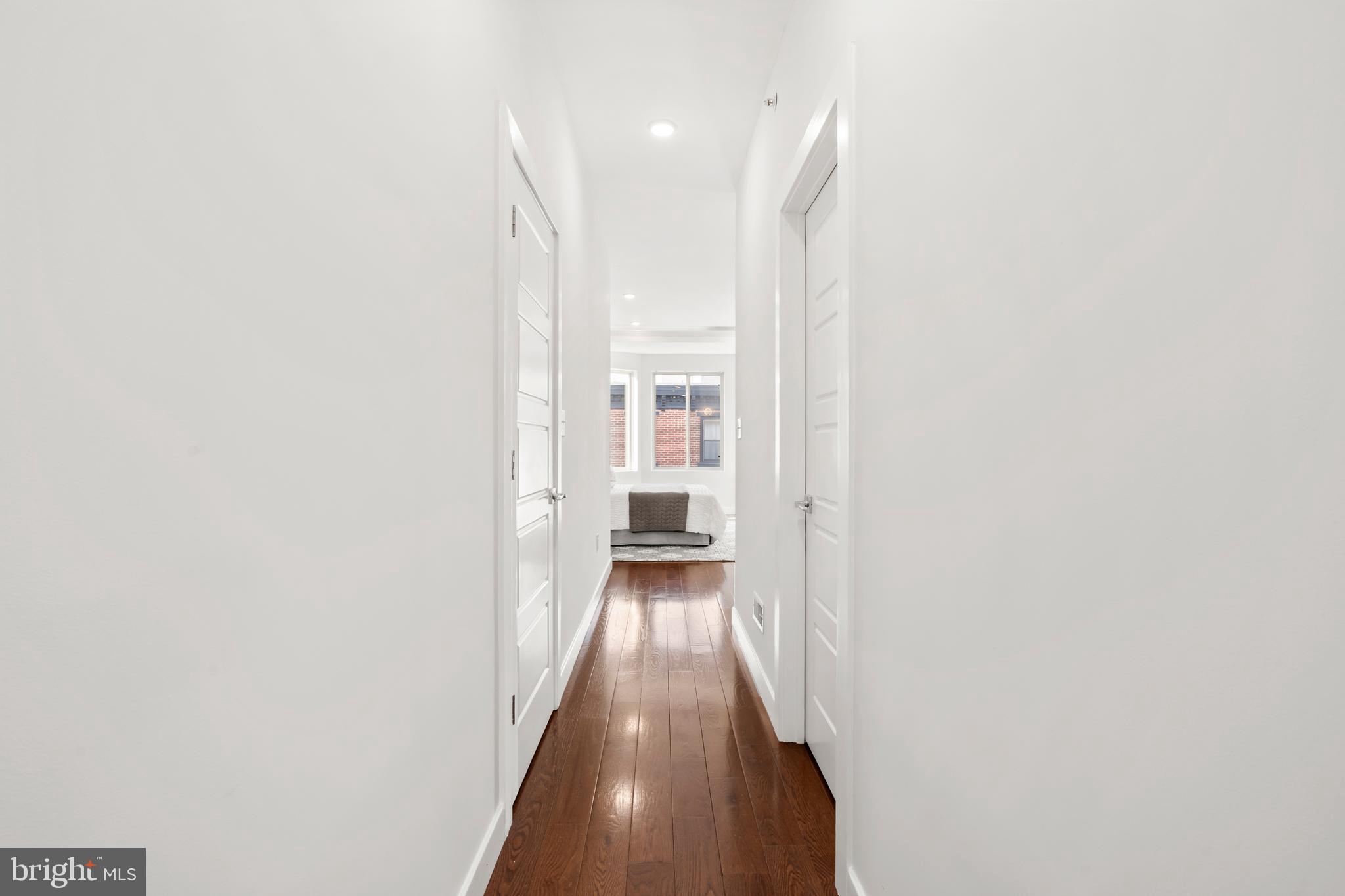 827 Leland Street Philadelphia, PA 19130 - Photo 19 of 40 a view of a hallway with wooden floor and a bathroom