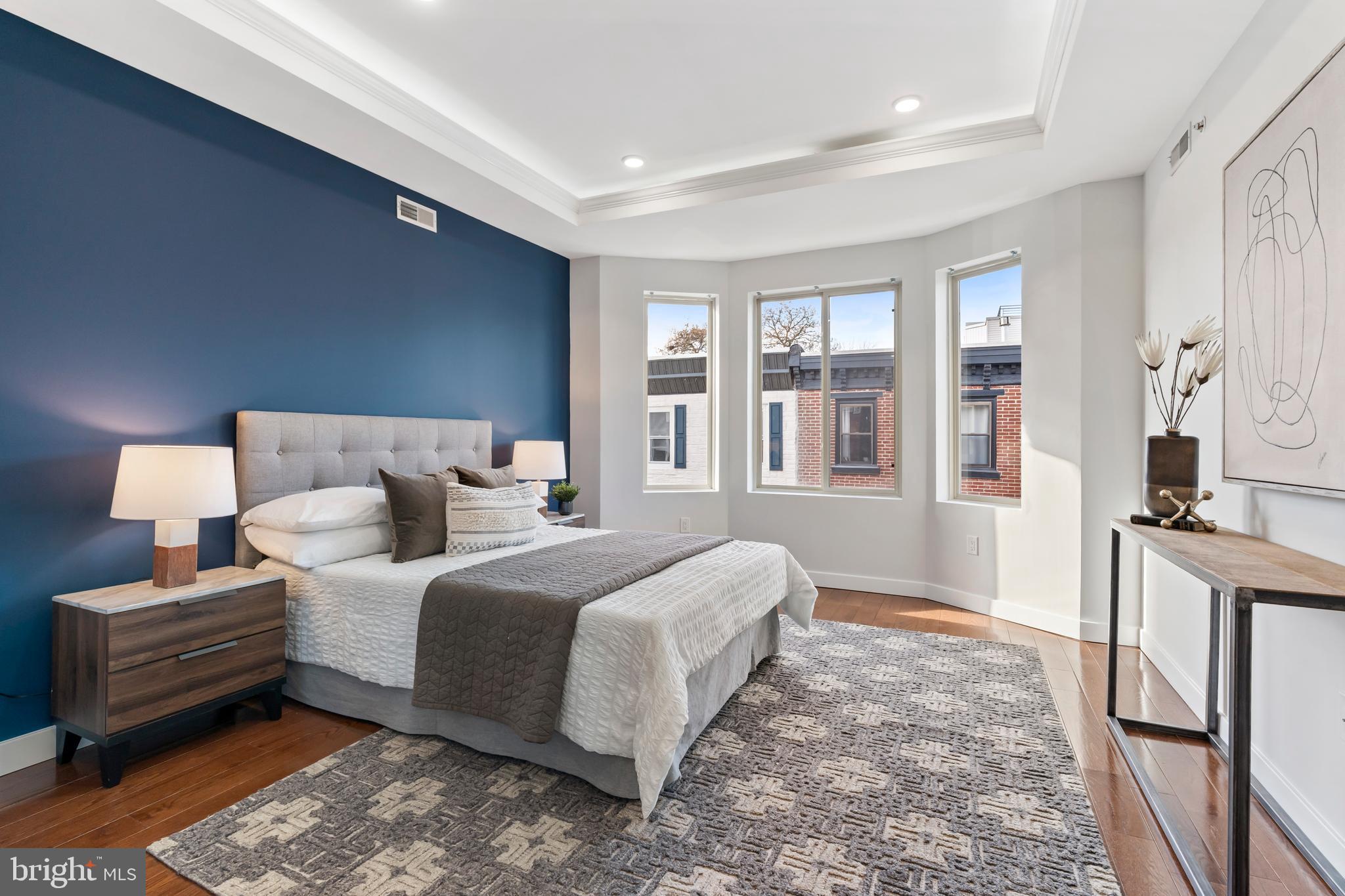 827 Leland Street Philadelphia, PA 19130 - Photo 20 of 40 a spacious bedroom with a bed and a large window