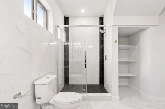 a bathroom with a toilet a sink and shower