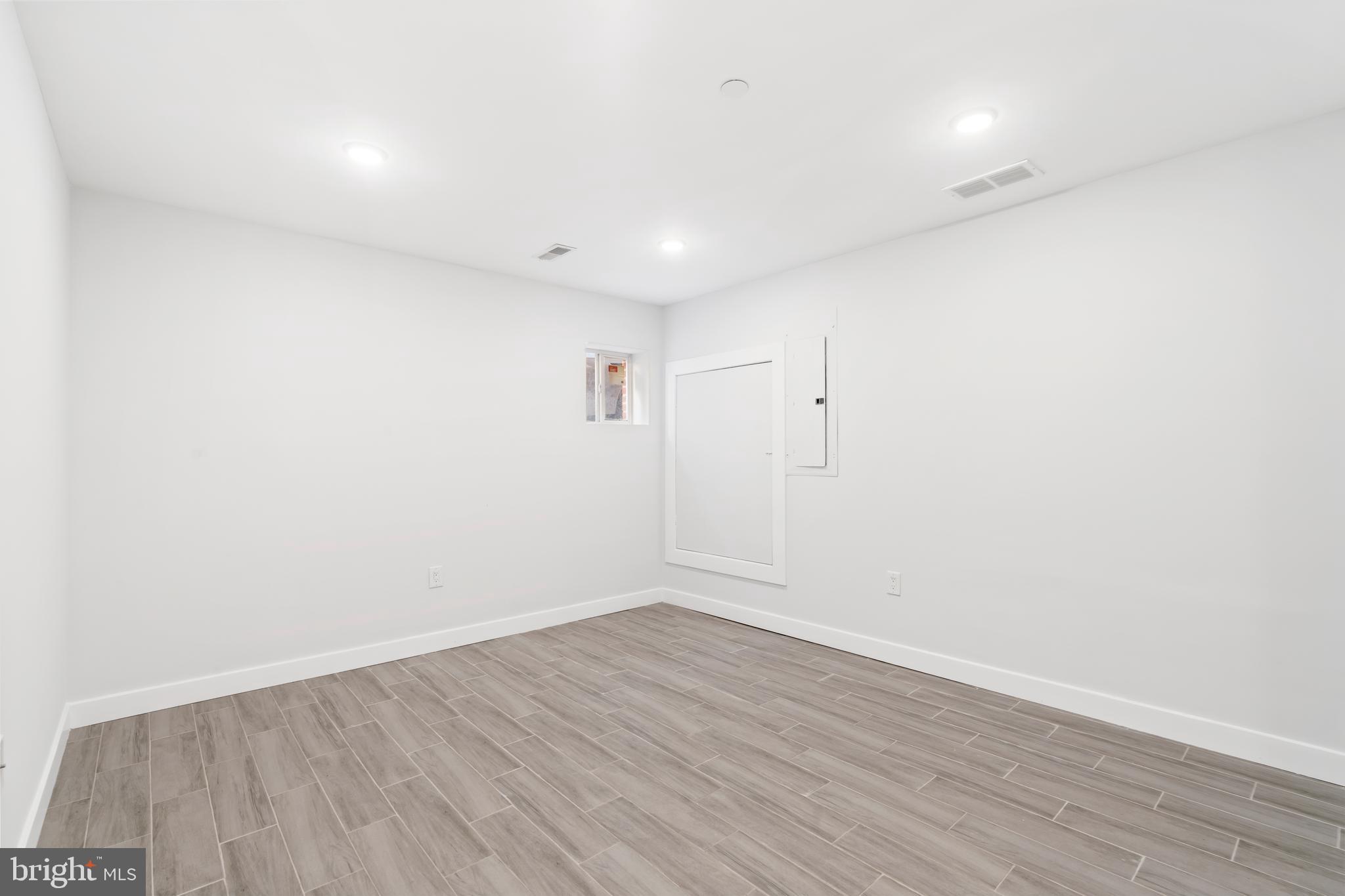 827 Leland Street Philadelphia, PA 19130 - Photo 30 of 40 wooden floor in a hall with a window