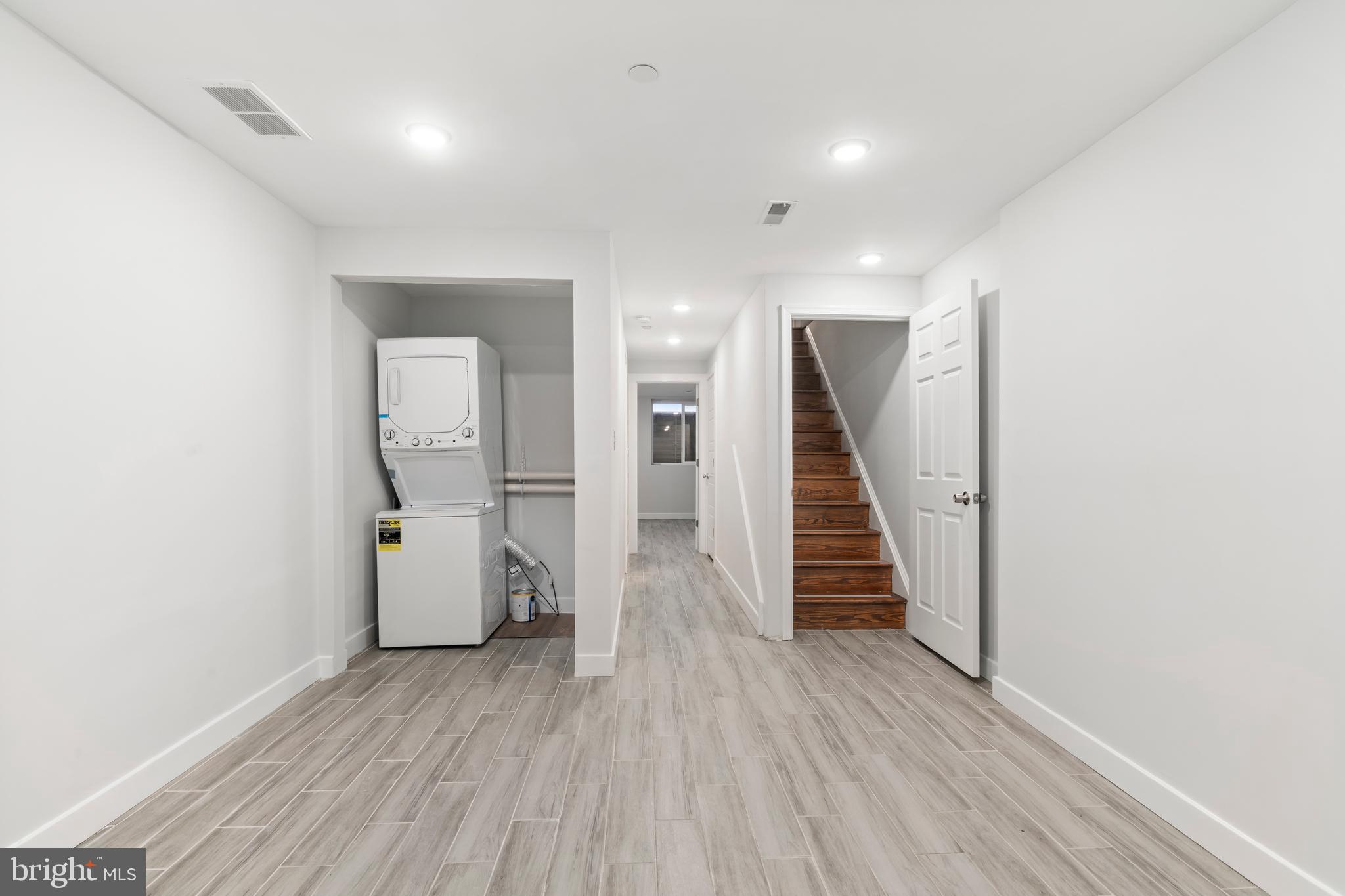 827 Leland Street Philadelphia, PA 19130 - Photo 31 of 40 a view of a hallway with wooden floor and staircase
