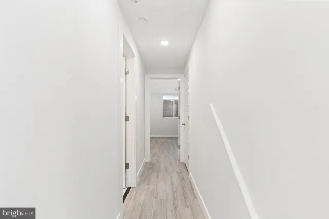 a view of a room with wooden floor