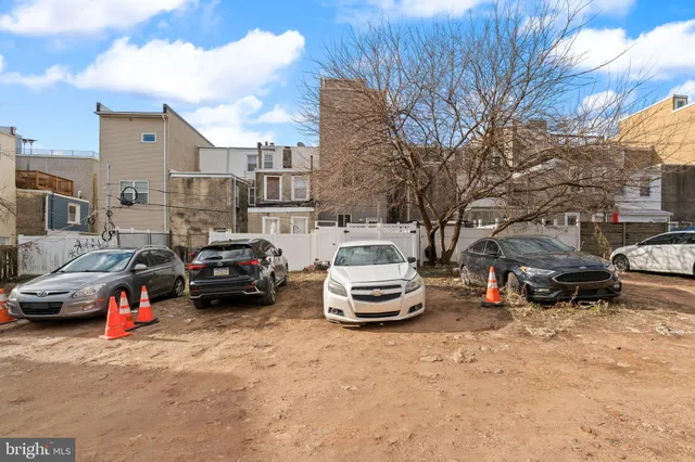 a view of a cars park in front of a building