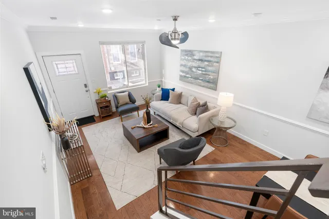 a living room with furniture and wooden floor