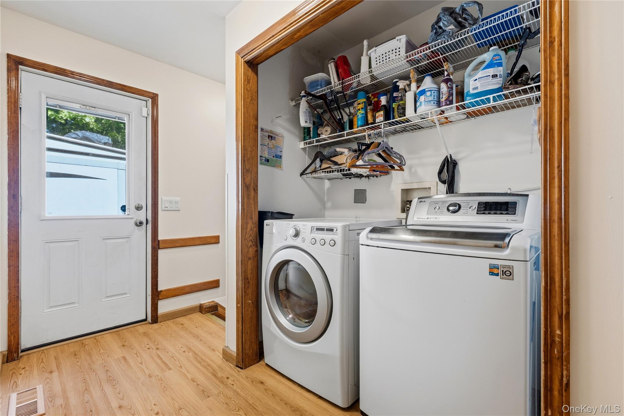 239-241 Fosler Road Highland, NY 12528 - Photo 15 of 42 Dedicated laundry area featuring a full-size washer and dryer hookup, wire shelving, and wood-finish flooring