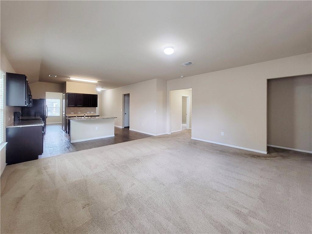 11924 Riparian Road Manor, TX 78653 - Photo 3 of 14 a view of empty room with a kitchen