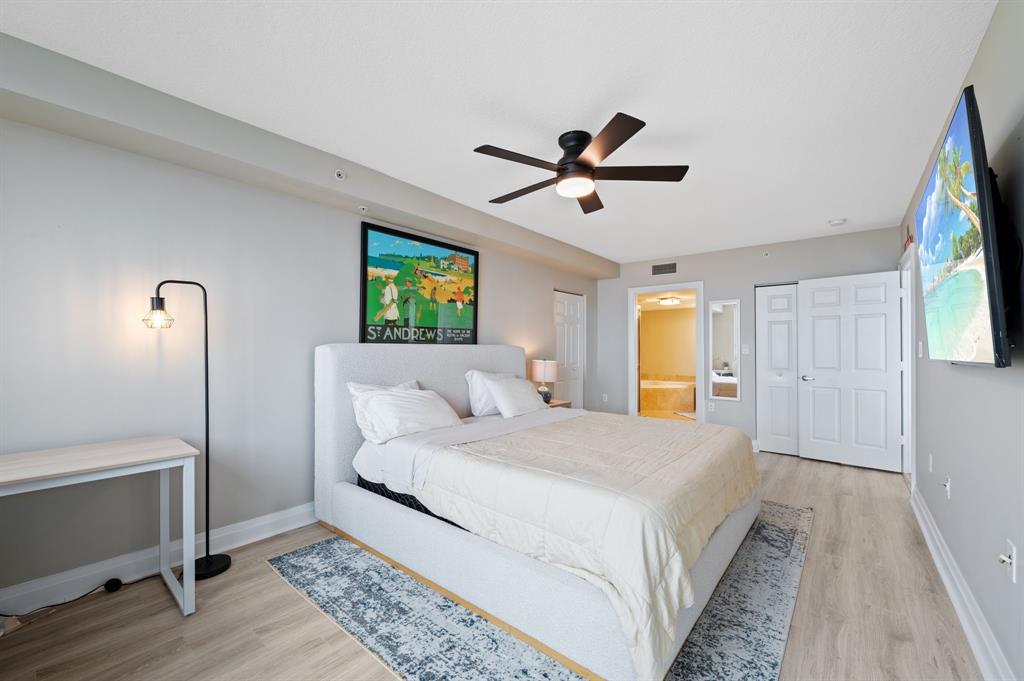 2011 North Ocean Boulevard, Unit 1605 Fort Lauderdale, FL 33305 - Photo 13 of 52 a bedroom with a large bed and a chandelier