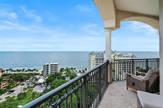 a view of a balcony with chairs and a table