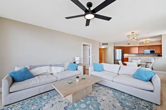 a living room with furniture and a chandelier