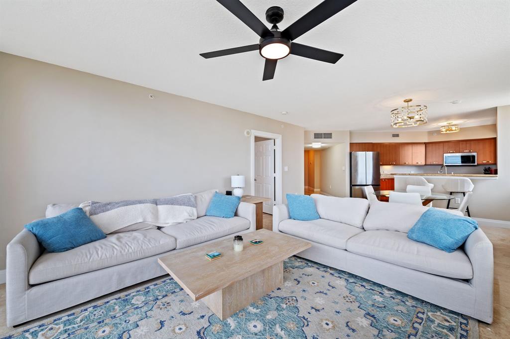 2011 North Ocean Boulevard, Unit 1605 Fort Lauderdale, FL 33305 - Photo 4 of 52 a living room with furniture and a chandelier