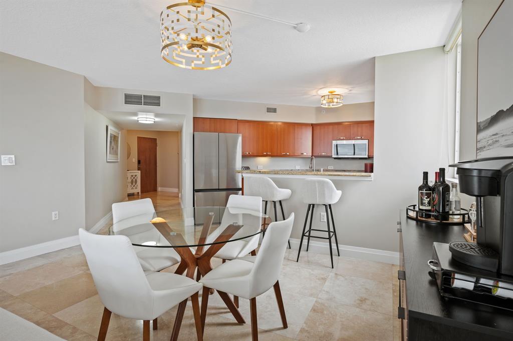 2011 North Ocean Boulevard, Unit 1605 Fort Lauderdale, FL 33305 - Photo 10 of 52 a view of a dining room with furniture and wooden floor