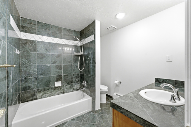 3535 Homestead Road Park City, UT 84098 - Photo 52 of 81 Full bathroom featuring a tiled shower-tub combination with a decorative band, a white porcelain tub, and an integrated shower head