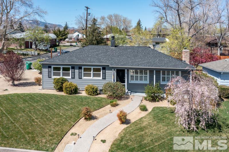1695 Lander Street Reno, NV 89509 - Photo 1 of 38 a front view of a house with a yard and outdoor seating