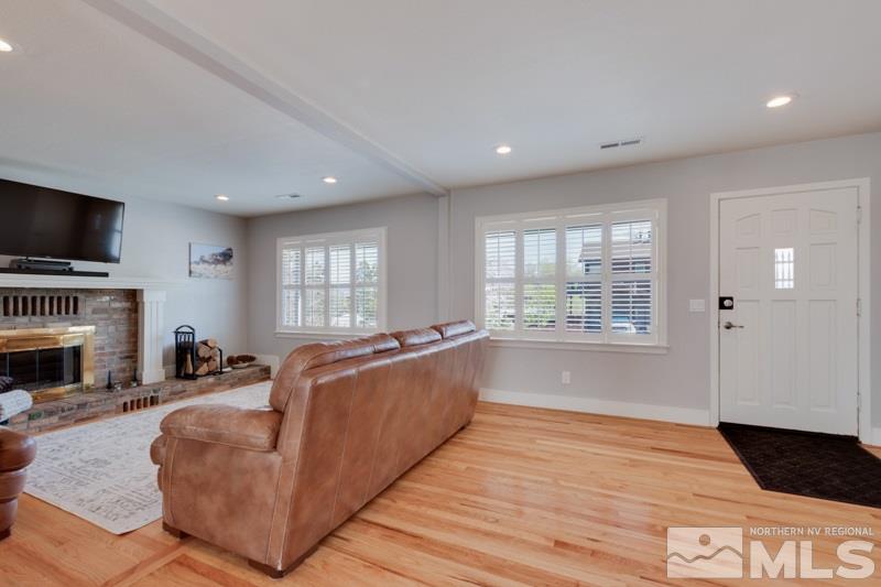 1695 Lander Street Reno, NV 89509 - Photo 12 of 38 a living room with furniture a flat screen tv and a fireplace