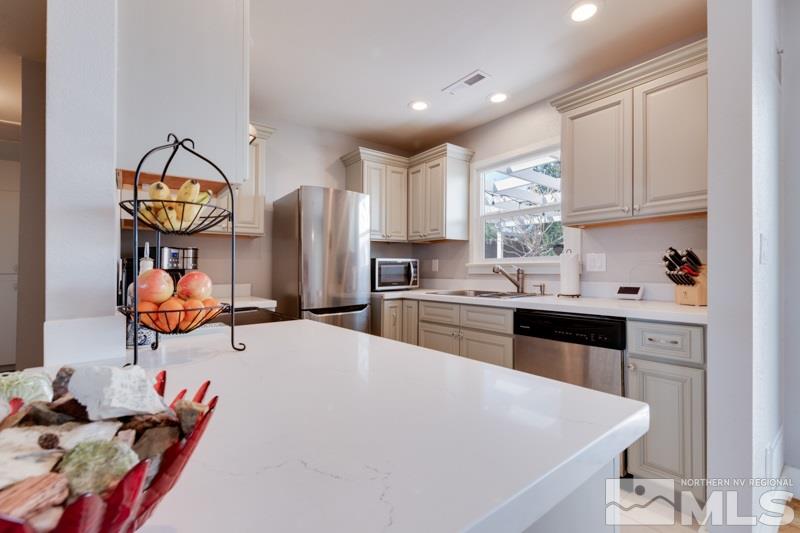 1695 Lander Street Reno, NV 89509 - Photo 16 of 38 a kitchen with stainless steel appliances a stove a sink cabinets and a refrigerator
