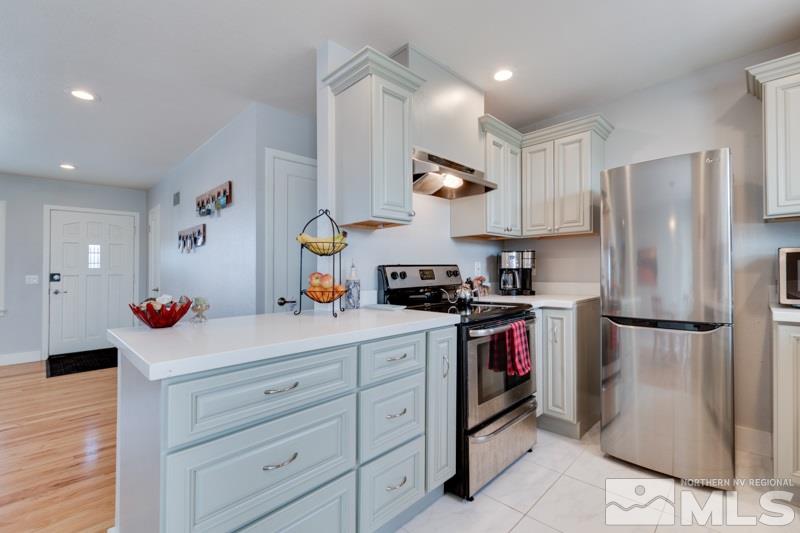 1695 Lander Street Reno, NV 89509 - Photo 17 of 38 a kitchen with refrigerator a sink and a stove