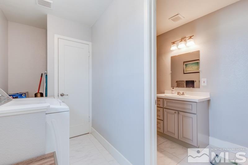 1695 Lander Street Reno, NV 89509 - Photo 18 of 38 a bathroom with a sink a toilet and mirror